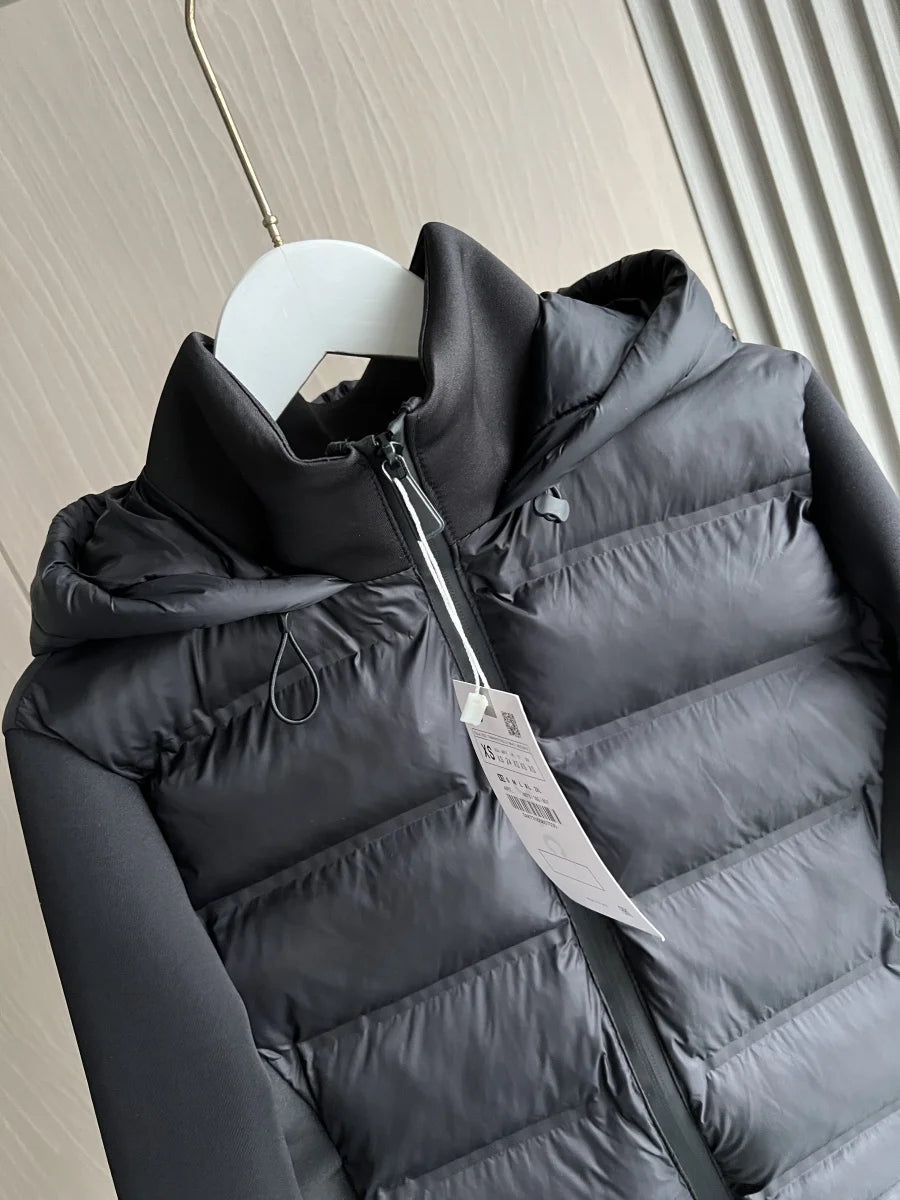 Black puffer jacket with hood and zipper, hanging on white hanger, modern texture backdrop