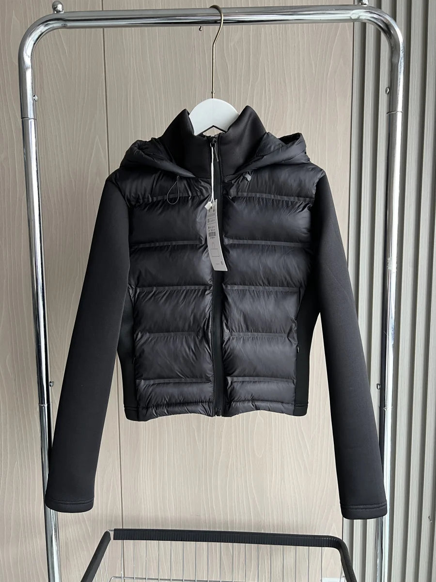 Black puffer jacket with hood and long sleeves on hanger, modern minimalist style